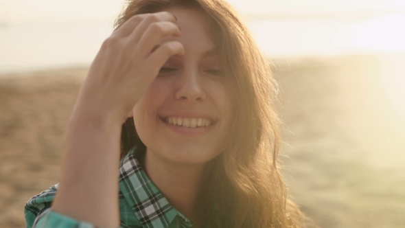 Of a Smiling Relaxed Young Blond Looking Away At The Beach, Stock Footage