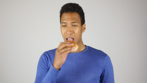 Hungry Man Eating Burger, Taking Bite of Burger alt