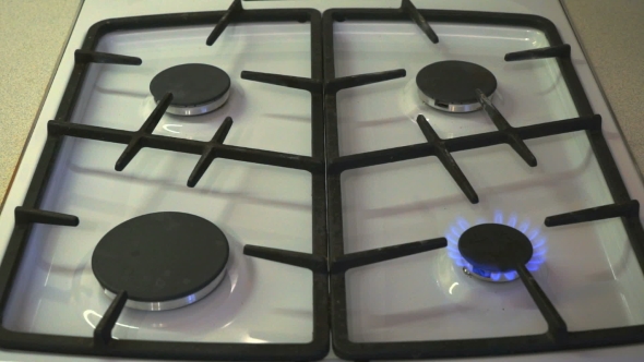 Four Gas Burners Burn Blue Flame On a Gas Stove alt