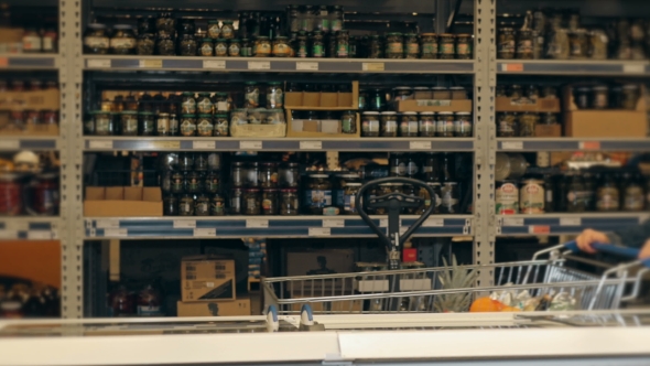 Handsome Man Shopping In A Supermarket, Taking Frozen Food From Freezer alt