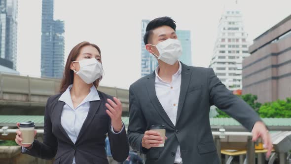 Asian couple office business people stand outdoor in city with confident face holding hot coffee. alt