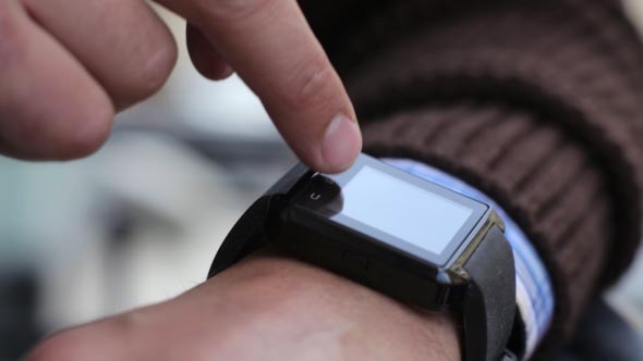 Man in the City Using Smart Watches alt