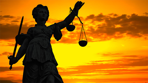 Statue of Lady Justice With a Colorful Sunset Background