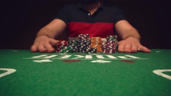 Male Player Betting All Chips in While Playing in Casino Close Up