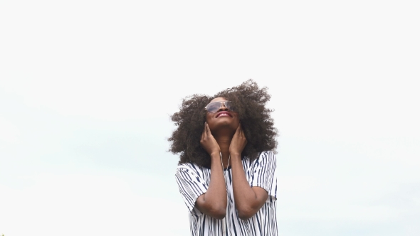 Cheerful Hipster Young African American Woman In Sunglasses Listening Music And Smiling