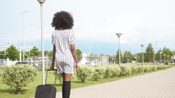 Full-length Back View Of Elegant Smiling African American Business Lady Going To The Airport