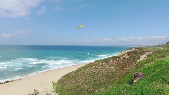 Paragliders Fly Over The Ocean Beach