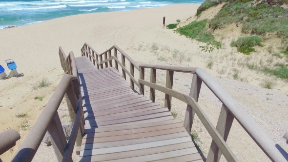 Walk Down Via Wooden Stairs With Railing