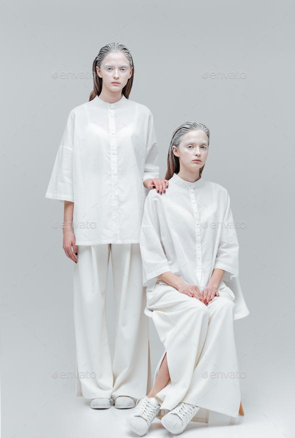 Two girls wearing white clothes Stock Photo by vadymvdrobot