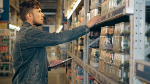 Manager With Tablet PC Checking Goods at Supermarket Warehouse alt