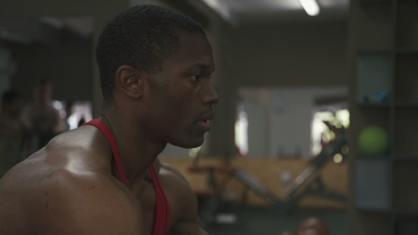 Muscular Sweaty Bodybuilder With Working With Barbell at the Gym