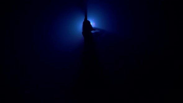 Woman Dancing on Pylon in the Dark