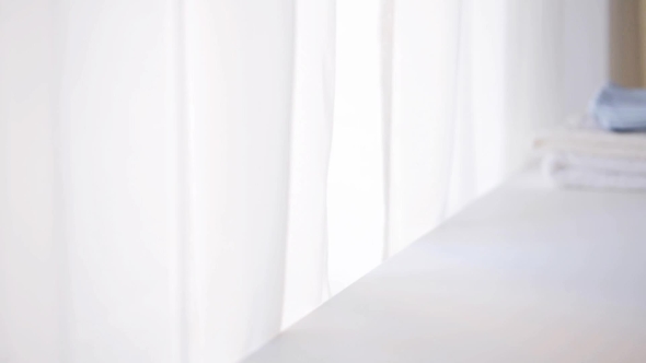 Woman Hand Putting Bootees On Baby Boys Clothes 3 alt