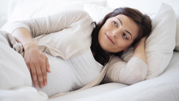 Happy Pregnant Woman Touching Her Tummy At Home 17 alt