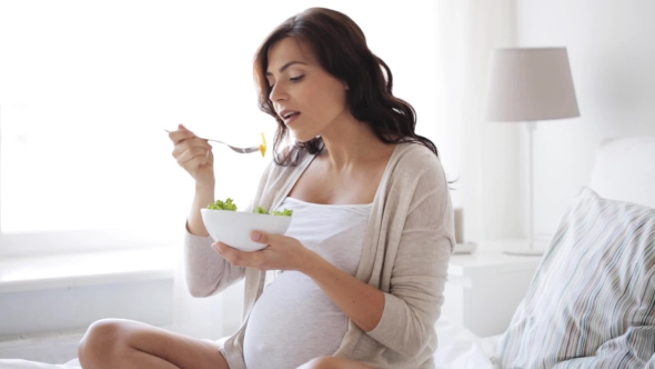 Pregnant Woman Eating Salad In Bed At Home 3, Stock Footage | VideoHive