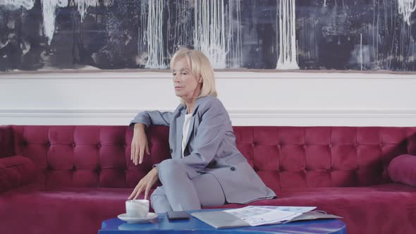 Woman Having Cellphone Discussion via Wireless Earphones alt