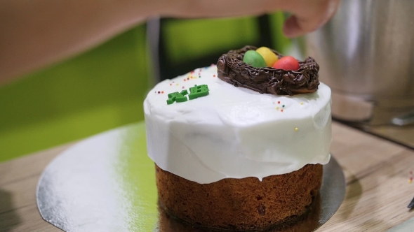 Female Hands Decorating Homemade Easter Cake
