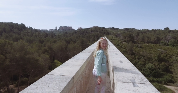 Tourist Girl Walk Thru The Ancient Devil's Aqueduct