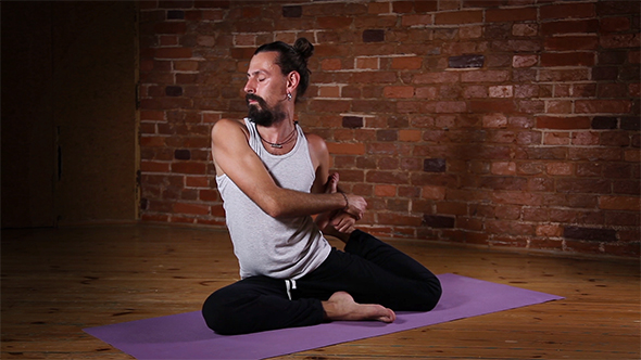 Man Doing Yoga Exercises Indoors