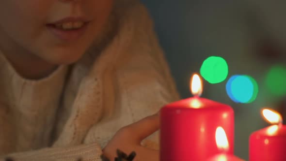 Little Girl Making Wish for Christmas and Blowing Out Candles, Faith in Miracle
