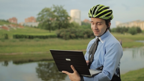 Businessman With Helmet And Laptop
