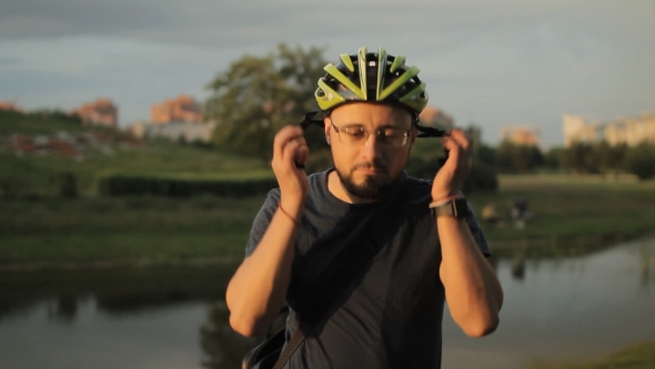 The Man Wears a Bicycle Helmet And Removes It