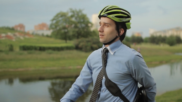 Businessman On Bicycle With Tablet And Helmet