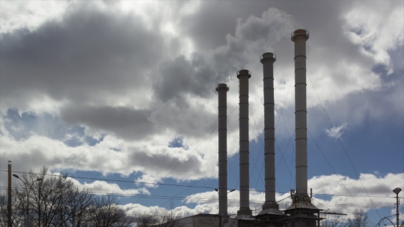  Of Tall Smoking Stacks Of Old Plant Against Sunny Blue Sky.