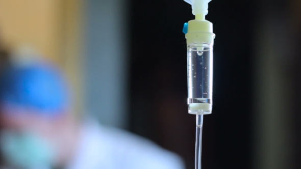 Intravenous Drip Dropper Against Background Of a Doctor 2, Stock Footage