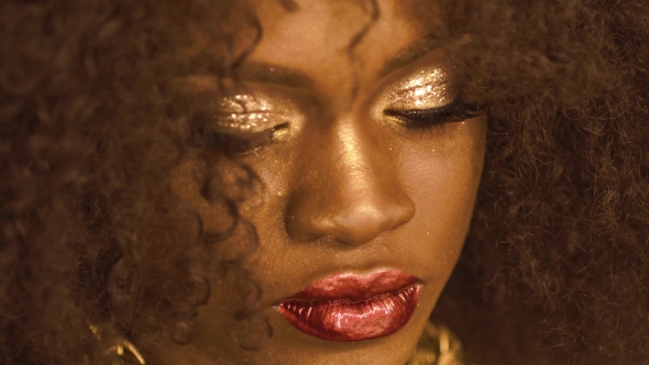 Surreal Portrait Of African American Female Model With Gold Glossy Makeup And Big Red Lips