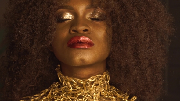 Magic Surreal Golden African American Female Model With Bright Glitter Makeup, Glossy Golden