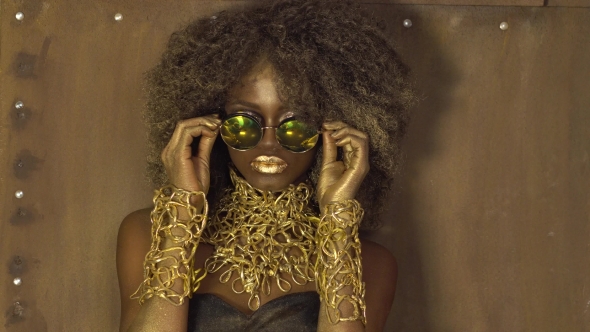 Magic Surreal Golden African American Female Model In Massive Sunglasses