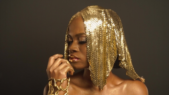 Studio Portrait Of Mysterious African American Woman With Golden Faceart