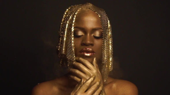 Enigmatic Magic African American Female Model With Golden Glossy Makeup