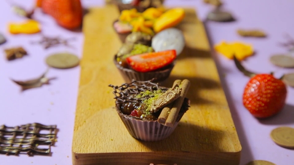 Chocolate Tartlets On a Wooden Board