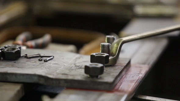 Worker Tightening The Screws alt