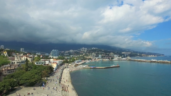 Tourists Walking On Seaside Embankment In City