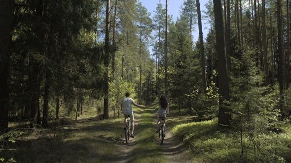 Young Couple Cycling In Nature