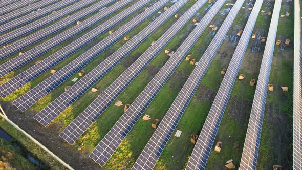 Aerial View of Solar Power Plant Under Construction on Green Field alt