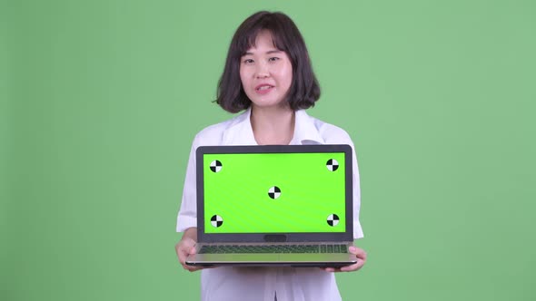 Happy Beautiful Asian Businesswoman Talking While Showing Laptop alt