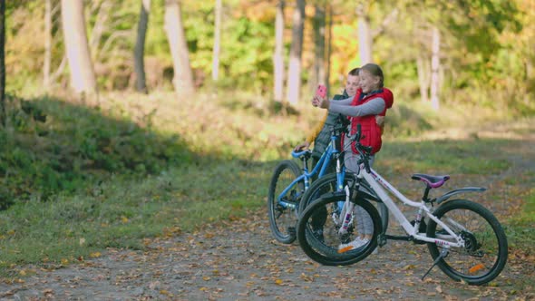 Children with a Bicycle are Photographed alt