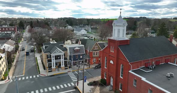 Religion in small town American. Christian church building on town square by homes in town. USA smal alt