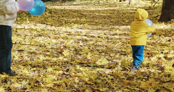 Small Child is Playing with His Mother in Inflatable Balloons alt