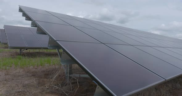 shots of solar panels on a solar farm alt