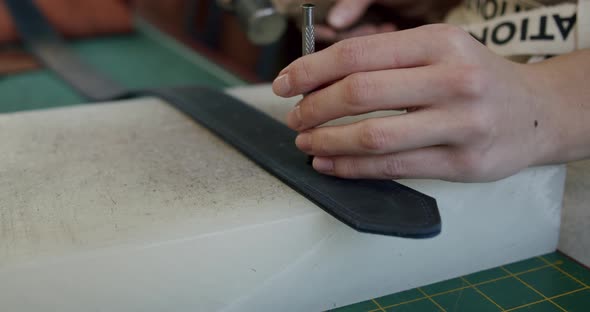 Close Up Shot of Specialist Working with Leather Female Hands of a Craftswoman Make Holes in a alt
