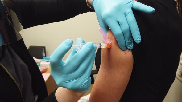 COVID-19 Vaccine Shot Given To An Adult Female Patient alt