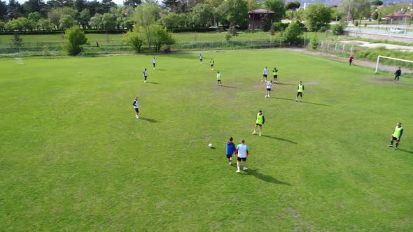 Aerial view of a football training in a football pitch on a summer day