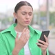 Upset Hispanic Woman Reacting to Loss on Smartphone Outdoor - VideoHive Item for Sale