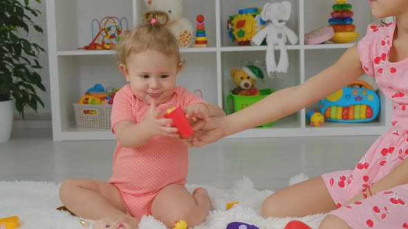 The Child Plays with Toys Together alt