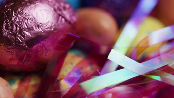 Rotating shot of colorful Easter candies on a bed of easter grass - EASTER  alt
